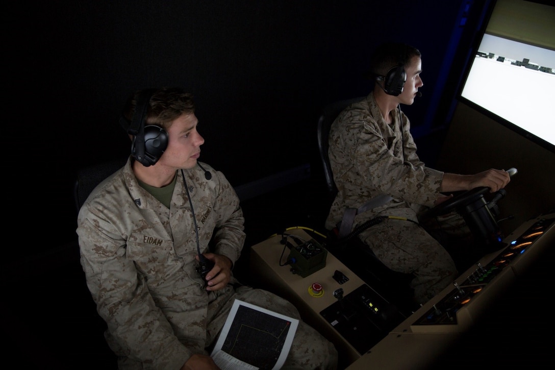 Cpl. Paul J. Eidam and Lance Cpl. Ryan A. Meredith, motor transport operators with 4th Medical Battalion, 4th Marine Logistics Group, Marine Forces Reserve, train in a virtual reality convoy simulator during Exercise Global Medic at Fort McCoy, Wisconsin, Aug. 17, 2016. The Marines were able to embark on a virtual convoy where they had to problem solve with issues that occurred along the way and safely make it to the rally point at the end of the route. (U.S. Marine Corps photo by Lance Cpl. Melissa Martens/Released)