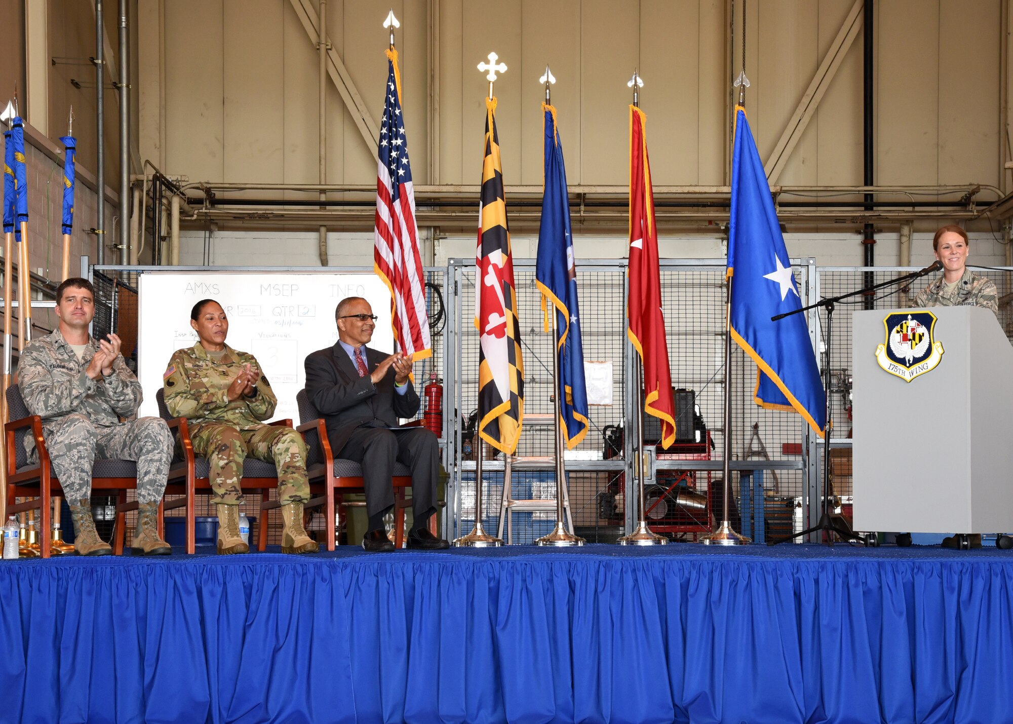 U.S. Air Force Brig. Gen. Randolph Staudenraus, 175th Wing commander, U.S Army Maj. Gen. Linda Singh, the adjutant general of Maryland and the State of Maryland Lt. Governor Boyd K. Rutherford applaud while U.S. Air Force Lt. Col. Jori Robinson initiates the commencement of the 175th Cyberspace Operations Group activation ceremony, August 21, 2016 at Warfield Air National Guard Base, Middle River, Md. The ceremony recognized the activation of the 175th COG, and its three squadrons, 275th Cyberspace Operations Squadron, 275th Operations Support Squadron, and the 276th Cyberspace Operations Squadron along with the re-designation of the 175th Cyberspace Operations Squadron and the 135th Intelligence Squadron. (U.S Air National Guard Photo by Airman 1st Class Enjoli Saunders/RELEASED)