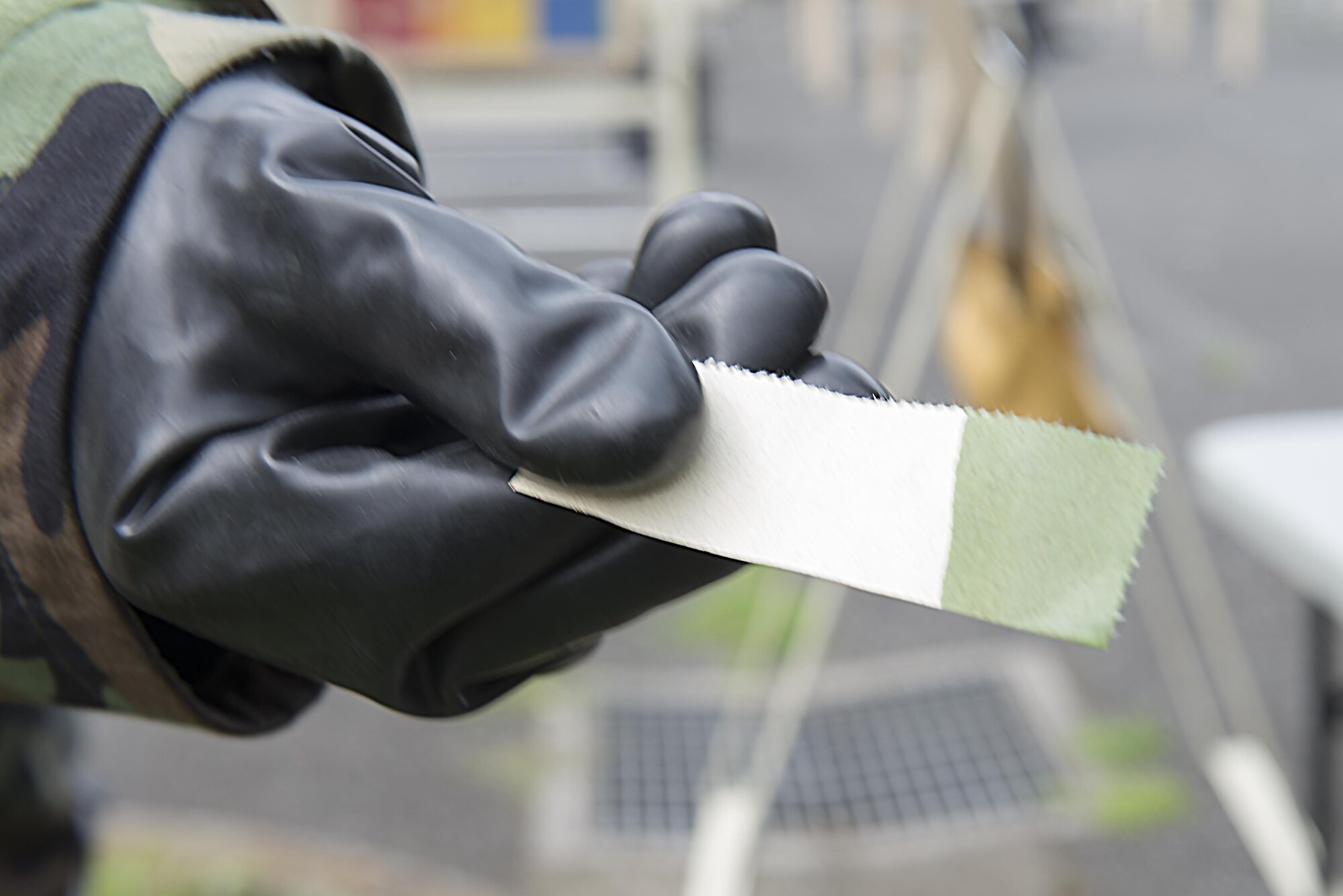 A piece of M8 chemical detection paper displays a false positive when exposed to ordinary cleaning agents during a Chemical, Biological, Radiological, Nuclear and Explosives defense class at the Camp Warlord training ground at Yokota Air Base, Japan, Aug. 10, 2016. The Airmen practiced CBRNE response, decontamination procedures and how to properly shelter-in-place. (U.S. Air Force photo by Senior Airman David C. Danford/Released)