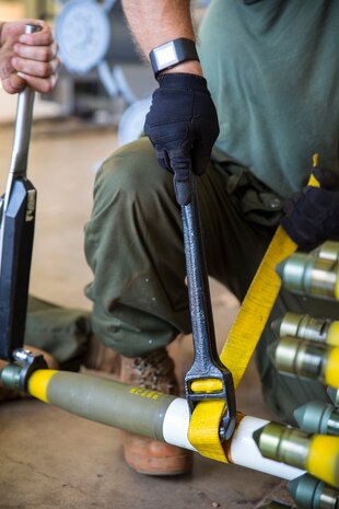 Marine Aviation Logistics Squadron (MALS) 12 Marines tighten a warhead onto a rocket during Southern Frontier at Royal Australian Air Force Base Tindal, Australia, Aug. 23, 2016. These ordnance Marines are working to meet Marine Fighter Attack Squadron (VMFA) 122’s goal of dropping 138 tons of ordnance during Southern Frontier. The unit level training afforded Iwakuni Marines the opportunity to train with high explosive weapon body groups typically not used in Japan, while expanding technical and tactical proficiency in their craft. Munitions built during this training are in support of VMFA-122, who also gains experience and qualifications in low altitude, air-ground, high explosive ordnance delivery at the unit level. (U.S. Marine Corps photo by Cpl. Nicole Zurbrugg)
