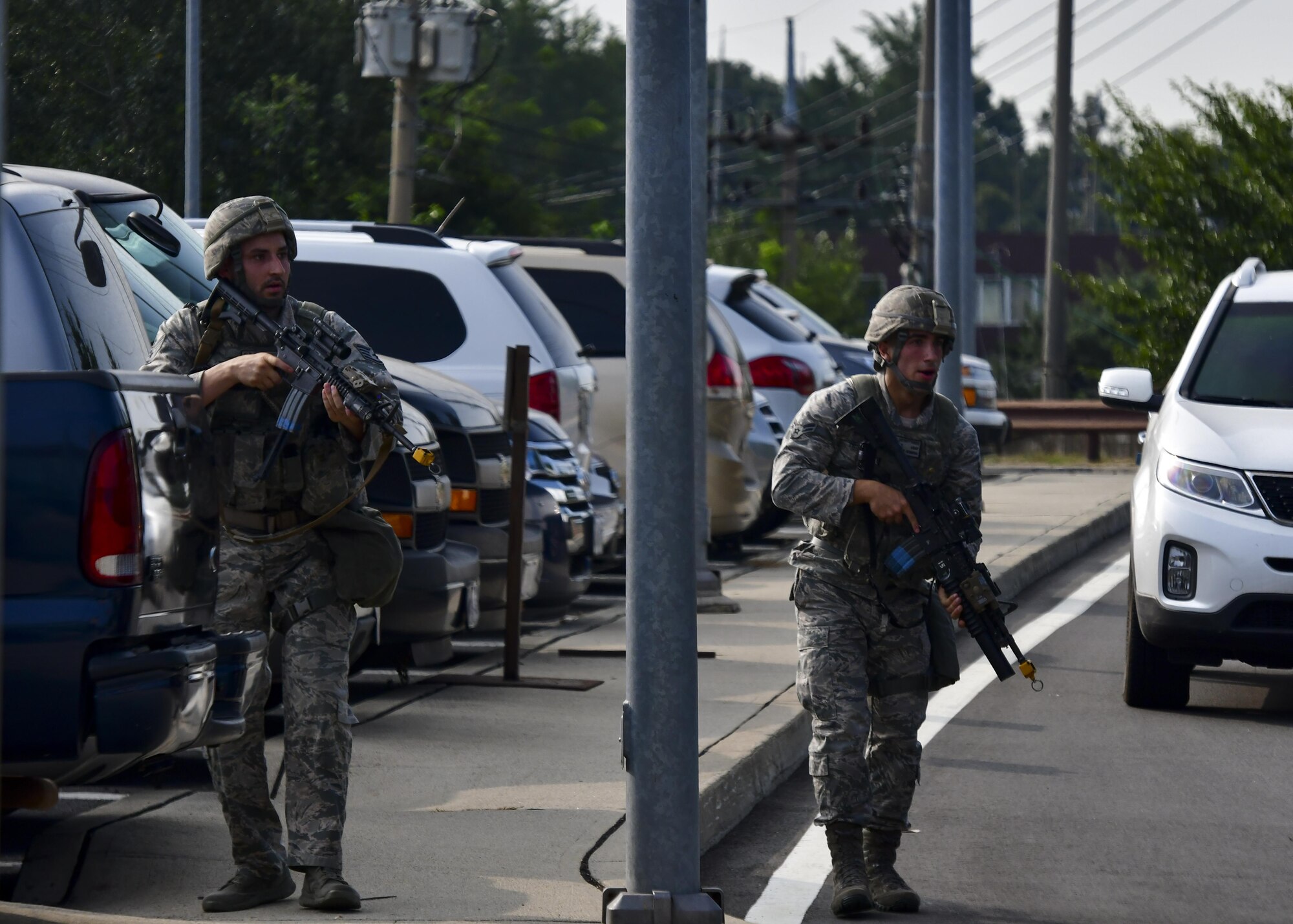 Defenders from the 51st Security Forces Squadron respond to gunfire from opposition forces during Exercise Beverly Herd 16-2 at Osan Air Base, Republic of Korea, Aug. 24, 2016. Defenders were deployed around Bldg. 1097 after reports of hostile forces were called in, swiftly backing up the personnel pre-positioned at that location. (U.S. Air Force photo by Senior Airman Victor J. Caputo)
