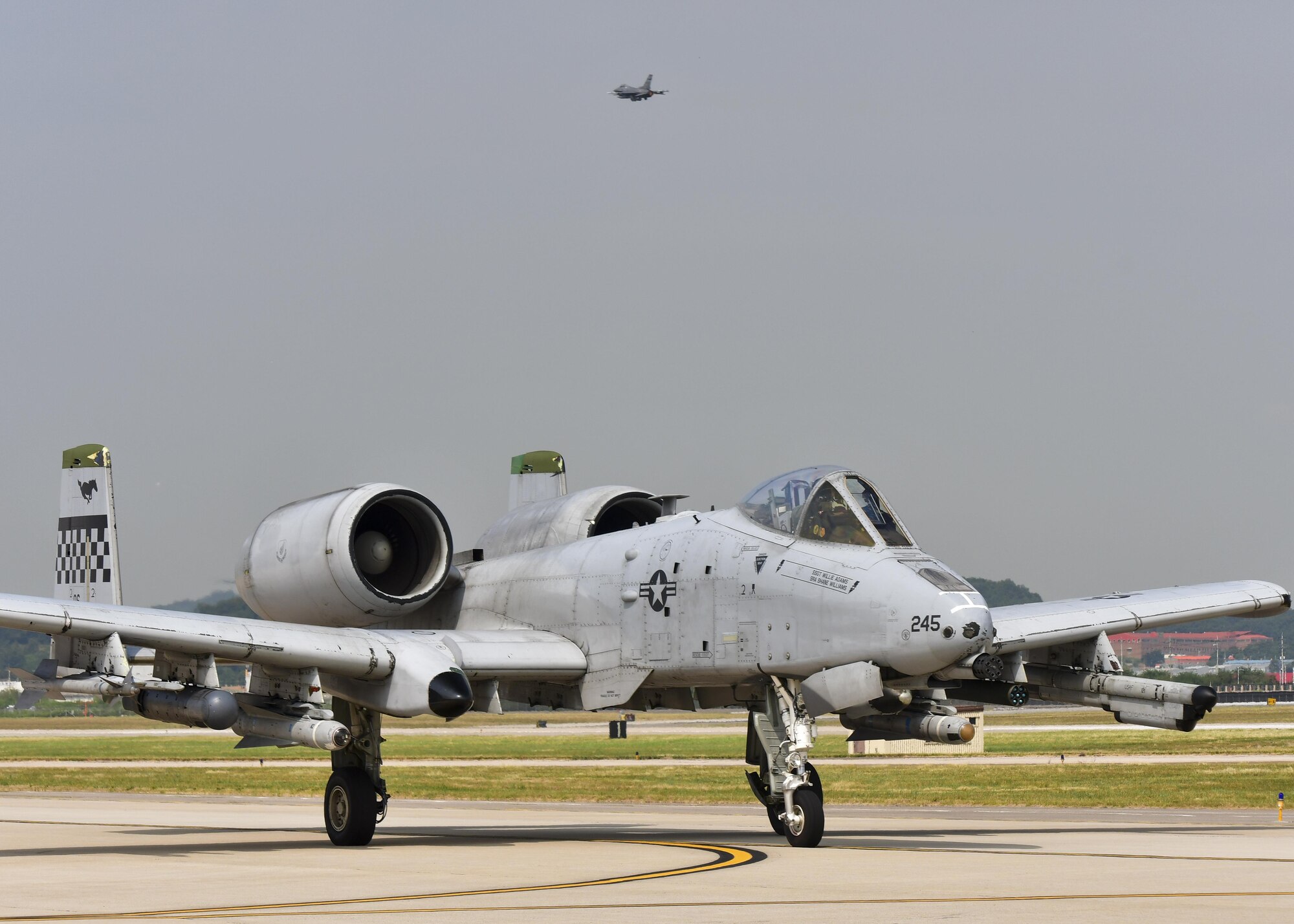 An A-10 Thunderbolt II, assigned to the 25th Fighter Squadron, taxis along the runway as an F-16 Fighting Falcon, assigned to the South Carolina Air National Guard 169th Fighter Wing, takes off during Exercise Beverly Herd 16-2 at Osan Air Base, Republic of Korea, Aug. 24, 2016. The two airframes were used to fly multiple sorties in support of the exercise, providing both pilots, maintenance and munitions Airmen the chance to hone their quick-turnaround skills. (U.S. Air Force photo by Senior Airman Victor J. Caputo)