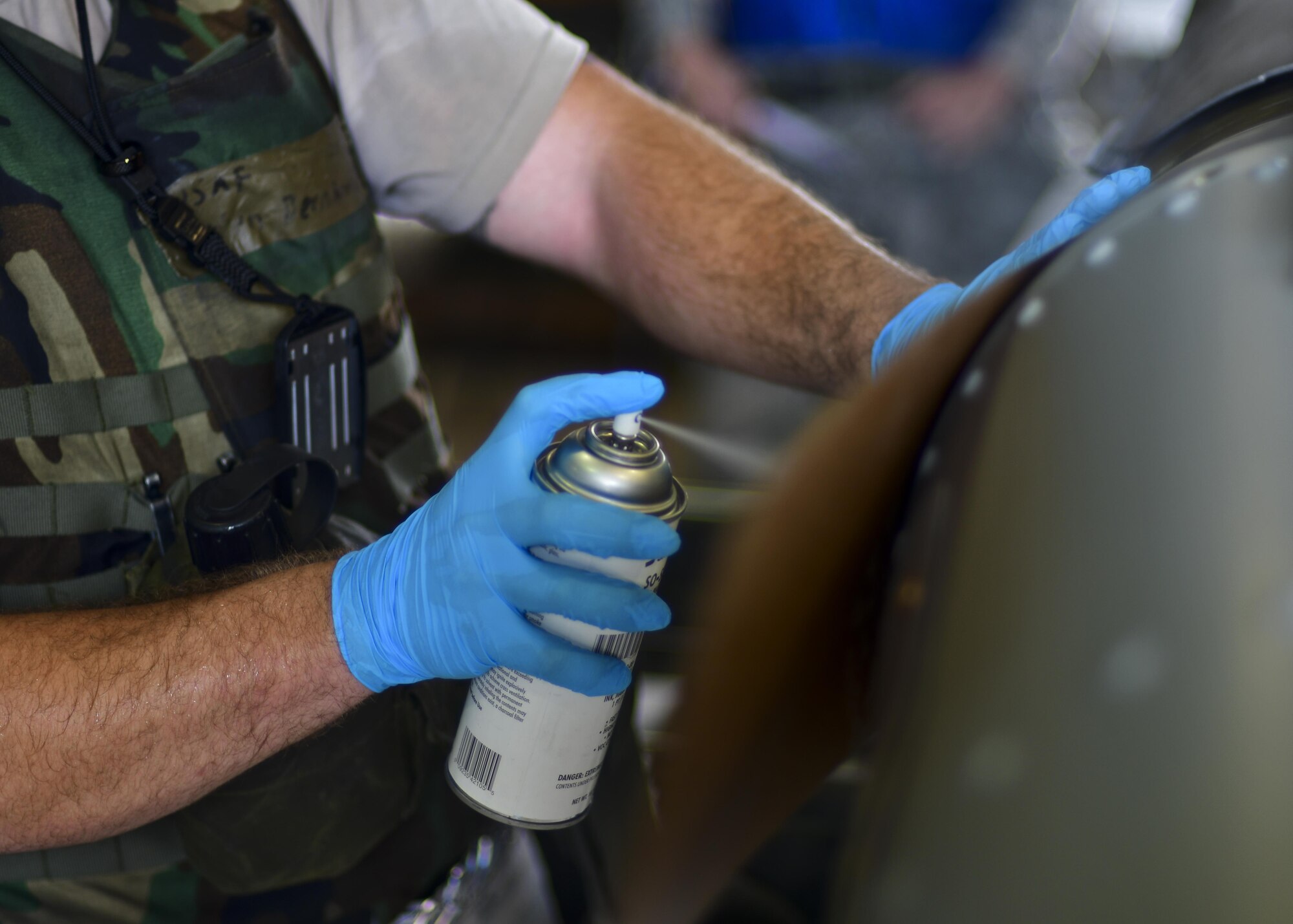 An Airman assigned to the 51st Munitions Squadron spray paints identification information onto a joint direct attack munition during Exercise Beverly Herd 16-2 at Osan Air Base, Republic of Korea, Aug. 24, 2016. Ammo Airmen are responsible for building and supplying the bombs and munitions used on the F-16 Fighting Falcon and A-10 Thunderbolt II in sorties flown out of Osan. (U.S. Air Force photo by Senior Airman Victor J. Caputo)