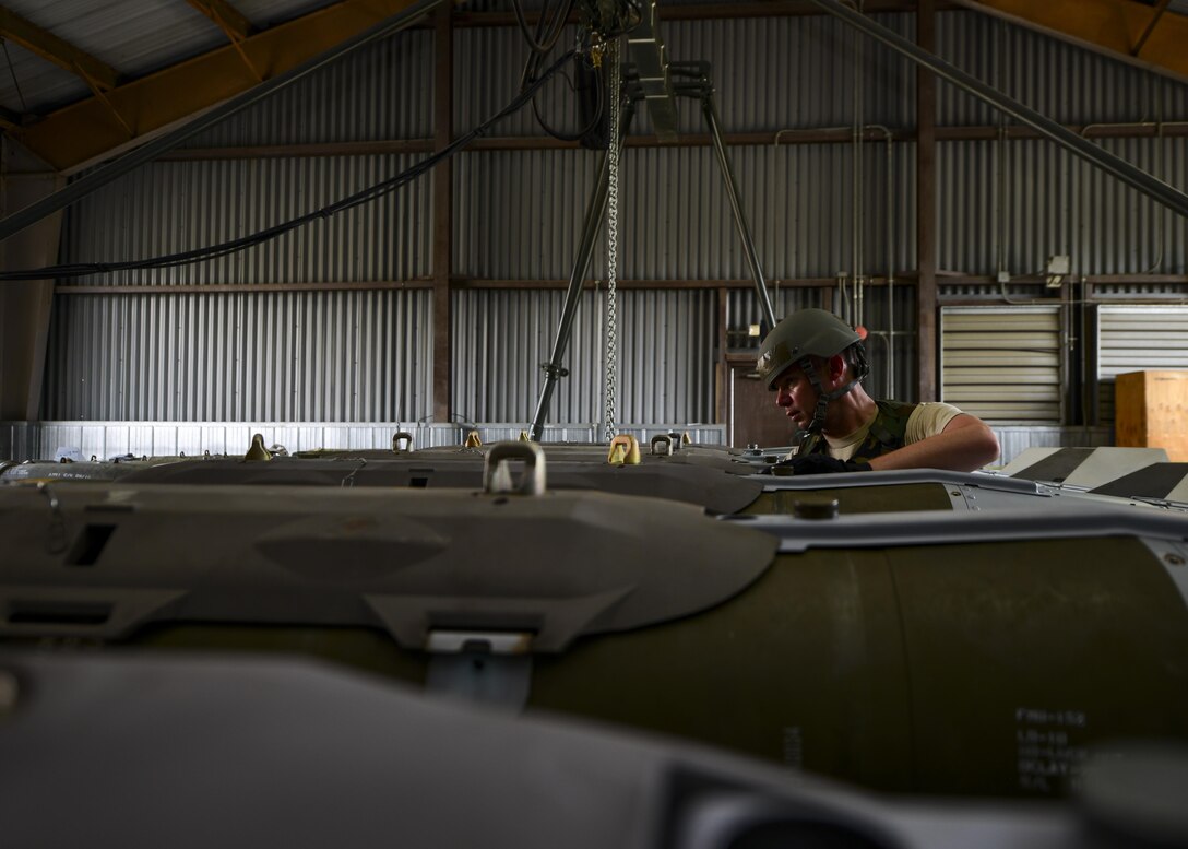 An Airman assigned to the 51st Munitions Squadron inspects a joint direct attack munition during Exercise Beverly Herd 16-2 at Osan Air Base, Republic of Korea, Aug. 24, 2016. The 51st MUNS is tasked with quickly, safely and efficiently building munitions for Team Osan aircraft on short notice. (U.S. Air Force photo by Senior Airman Victor J. Caputo)