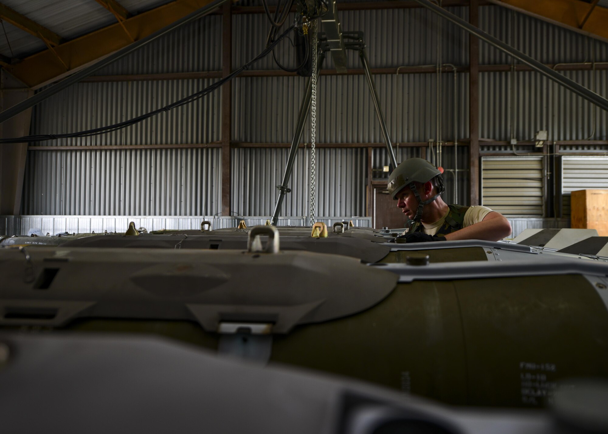 An Airman assigned to the 51st Munitions Squadron inspects a joint direct attack munition during Exercise Beverly Herd 16-2 at Osan Air Base, Republic of Korea, Aug. 24, 2016. The 51st MUNS is tasked with quickly, safely and efficiently building munitions for Team Osan aircraft on short notice. (U.S. Air Force photo by Senior Airman Victor J. Caputo)