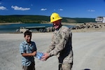 1st Sgt. Mike Ilko, 194th Engineer Brigade, Tennessee Army National Guard, shares bottled water with a young cattle herder Aug. 16, 2016, at Novo Selo Training Area, Bulgaria.  Local cattle and sheep herders regularly herd thier animals across NSTA.  Tennessee National Guard Soldiers and Airmen were on rotations to complete thier portions of projects as part of Operation Resolute Castle 16, an ongoing operation of military construction to build up Eastern European base infrastructure and help strengthen ties between Tennessee's state partnership with Bulgaria. 