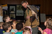 Jens Fleer, base falconer, Spangdahlem Air Base, Germany, introduces his falcon to a group of children from Kindergarten Spangdahlem, city of Spangdahlem, Germany, during Multicultural Awareness Day Aug. 18, 2016 at Club Eifel on base. Approximately 2,000 people attended the multicultural awareness event. (U.S. Air Force photo by Tech. Sgt. Amanda Currier)  