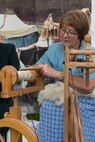 Monica Koster, from the Speicher Museum, Speicher, Germany, spins sheep wool on a spinning wheel during Multicultural Awareness Day Aug. 18, 2016, outside of Club Eifel, Spangdahlem Air Base, Germany. Koster, who showcased medieval culture at the event, served as one of approximately 250 volunteers from Spangdahlem and the local community who worked at Multicultural Awareness Day. (U.S. Air Force photo by Tech. Sgt. Amanda Currier)  
