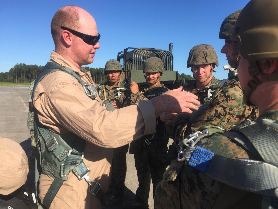 Marines with 2nd Air Delivery, 2nd Transportation Support Battalion check each other’s parachutes before they jump at Camp Davis, N.C., Aug. 17, 2016. The Marines in 2nd Air Delivery are jumping with the newly issued MC-7parachutes in order to be certified as basic airborne jumpers. (U.S. Marine Corps photo by Lance Cpl. Ashley Lawson) 
