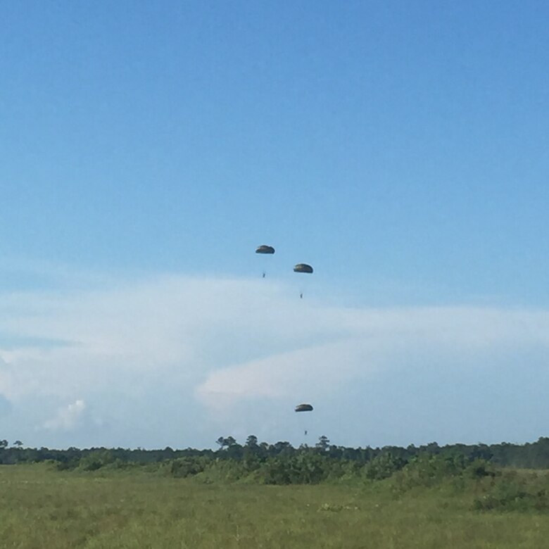 Marines with 2nd Air Delivery, 2nd Transportation Support Battalion deploy the MC-7 parachute as they descend from 2,000 ft. at Camp Davis, N.C., Aug. 17, 2016.The Marines are jumping with the newly Marine Corps issued MC-7 parachute instead of the older Army TS-11 to be qualified and effective with the newer equipment. (U.S. Marine Corps photo by Lance Cpl. Ashley Lawson) 160817-M-IH158-054
