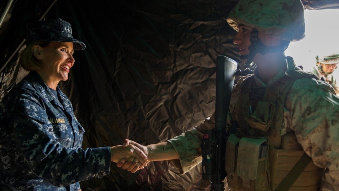 Lance Cpl. Vicente C. Spence, right, a motor transport operator with 4th Medical Battalion, 4th Marine Logistics Group, Marine Forces Reserve, receives a challenge coin from Rear Adm. Christina M. Alavarado, commander, reserve component expeditionary medicine, during Exercise Global Medic at Fort McCoy, Wisconsin, August 19, 2016. Spence was presented the coin for the continuous hard work he did throughout the course of the exercise and for constantly maintaining a positive and upbeat attitude. 