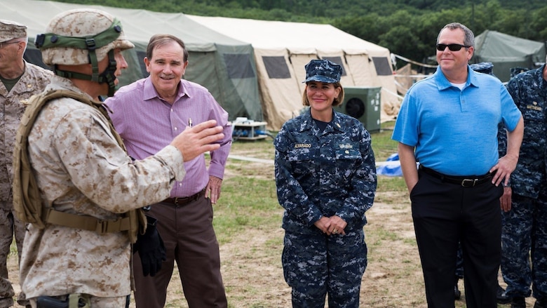 Navy Capt. Michael L. Reineke, left, commanding officer of Exercise Global Medic, provides distinguished visitors with an overview of the training the Marines and Navy personnel have been participating in throughout the course of the exercise at Fort McCoy, Wisconsin, August 19, 2016. The distinguished visitors included Dennis Biddick, second from the left, deputy assistant secretary of the Navy Reserve Affairs, Rear Adm. Christina M. Alavarado, second from right, commander, reserve component expeditionary medicine, and Dr. Andrew Jones, right, director of the Navy Total Force Bureau of Medicine and Surgery. 