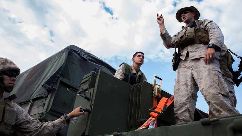 Sgt. Charles P. Retter, right, motor transport maintenance chief with 4th Medical Battalion, 4th Marine Logistics Group, Marine Forces Reserve, teaches Marines how to properly utilize new trailers for the 7-ton truck during Exercise Global Medic at Fort McCoy, Wisconsin, August 18, 2016. By explaining how new equipment is used, Retter is ensuring that his Marines will be ready in a combat zone to use their skills to fulfill the mission requirements. 