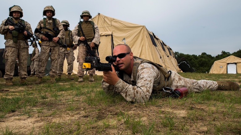 Cpl. Kristophor K. Allison, motor transport operator with 4th Medical Battalion, 4th Marine Logistics Group, Marine Forces Reserve, teaches a class on proper weapons handling and techniques to Navy personnel during Exercise Global Medic at Fort McCoy, Wisconsin, August 19, 2016. Participants had the opportunity to cross train with other branches and other military occupational specialties to develop different skills throughout the course of the exercise. 