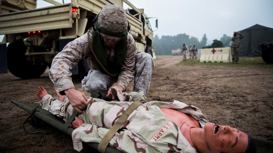 Sgt. Mathew W. Dearborn, data networking specialist with 4th Medical Battalion, 4th Marine Logistics Group, Marine Forces Reserve, searches a simulated casualty for weapons and contraband before he can be brought to the Shock Trauma Platoon for treatment during Exercise Global Medic at Fort McCoy, Wisconsin, August 17, 2016. Marines provided security for the STP to ensure that victims were not hiding explosives or other harmful substances on their body and that unauthorized personnel were not entering the STP. 