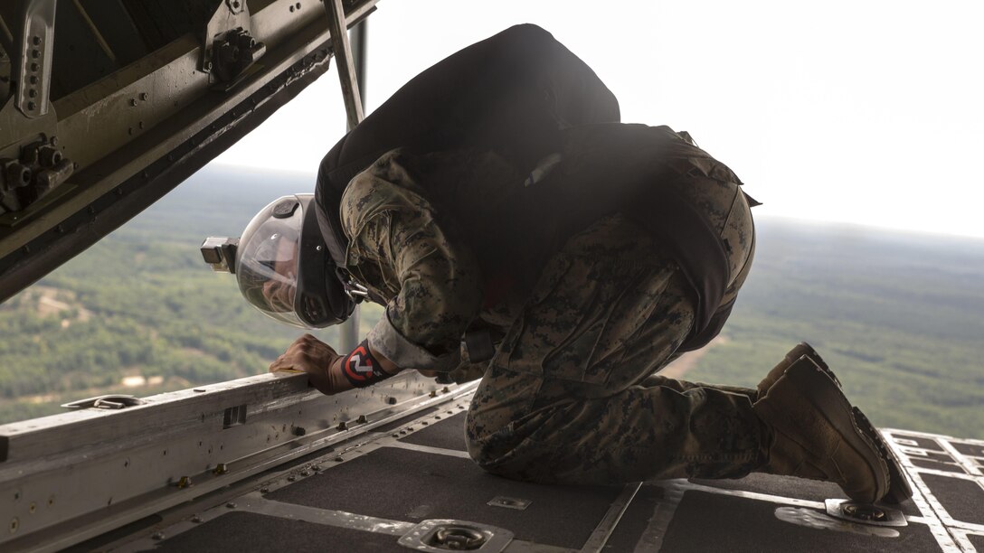Sgt. Juan Gonzalez, paraloft chief for Company C, 4th Reconnaissance Battalion, Marine Forces Reserve, checks the distance left before a jump during Exercise Northern Strike 2016 at Camp Grayling Joint Maneuver Training Center, Mich., Aug. 16, 2016. Reserve Recon Marines practice jumping from the back of C-130s to meet their requirements and perfect their skills.  Exercise Northern Strike 16 is a National Guard Bureau-sponsored exercise uniting approximately 5,000 Army, Air Force, Marine, and Special Forces service members from 20 states and three coalition countries. The exercise strives to provide accessible, readiness-building opportunities for military units from all service branches to achieve and sustain proficiency in conducting mission command, air, sea, and ground maneuver integration, and the synchronization of fires in a joint, multinational, decisive action environment.