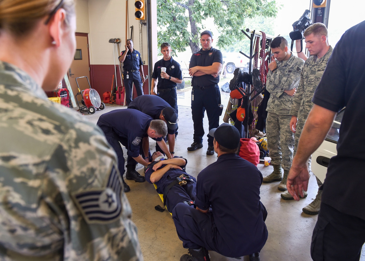 Medics from the 59th Medical Wing observe as members the San Antonio Fire Department technical rescue team extract a simulated patient from a vehicle Aug. 13, 2016 at Fire Station 11 in San Antonio. The joint training gave participants an opportunity to strengthen their partnership, which will benefit the citizens they serve.  (U.S. Air Force photo/Staff Sgt. Michael Ellis)
