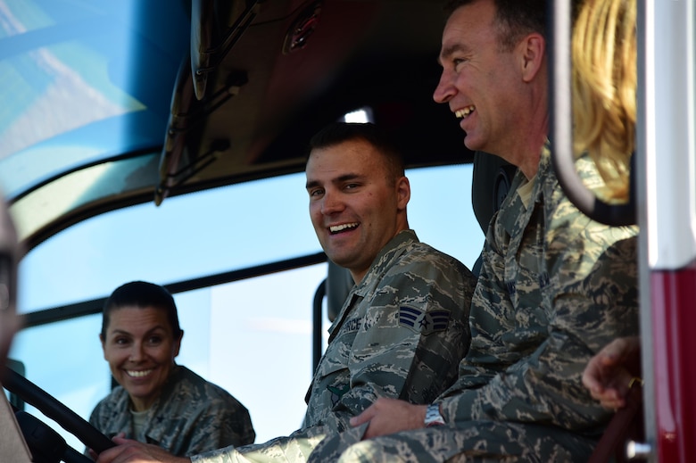 PETERSON AIR FORCE BASE, Colo. - Brig. Gen. Chad Franks, 14th Air Force vice commander, and Brig. Gen. Pamela Lincoln, 14th Air Force mobilization assistant to the commander, are briefed by Senior Airman Anthony Pipes, 21st Civil Engineer firefighter, on the controls for the water canon attached to one of the flightline crash tender trucks on Peterson Air Force Base, Colo., Aug. 16, 2016. The crash tender is a specialized fire engine designed for use in aircraft rescues. The high-pressure nozzle is used to penetrate an aircraft’s fuselage in order to fight the fire.  (U.S. Air Force photo by Staff Sgt. Amber Grimm) 