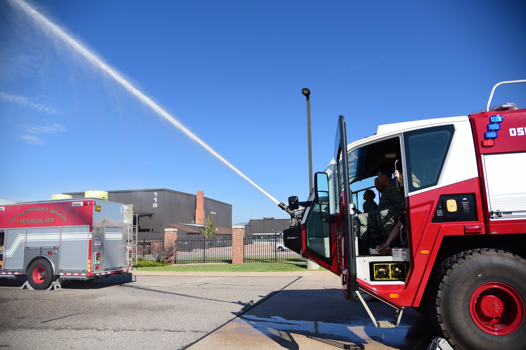 PETERSON AIR FORCE BASE, Colo. - Senior Airman Anthony Pipes, 21st Civil Engineer firefighter, demonstrates the water canon attached to one of the flightline crash tender trucks on Peterson Air Force Base, Colo., Aug. 16, 2016. The crash tender is a specialized fire engine designed for use in aircraft rescues. The high-pressure nozzle is used to penetrate an aircraft’s fuselage in order to fight the fire.  (U.S. Air Force photo by Staff Sgt. Amber Grimm)