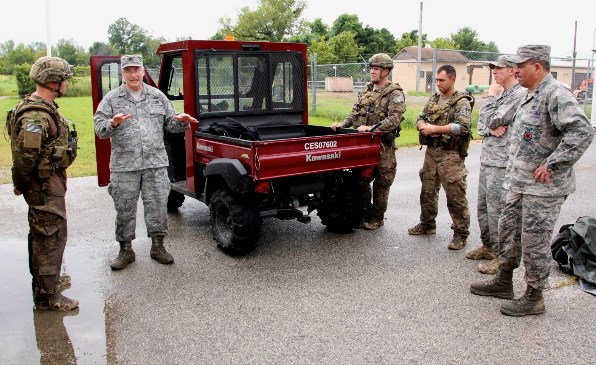 Some of the 932nd Airlift Wing's Explosive Ordnance Disposal team listens to the wing commander, Col. Jonathan Philebaum, talk about executing the EOD's difficult mission, and how he appreciated their work and the opportunity to spend time out in the field with them.  The 932nd Airlift Wing's Explosive Ordnance Disposal team went above and beyond their normal drill weekend, starting early in the morning preparing highly specialized equipment and then pushing themselves through the summer heat and humidity, deep into the forest during a rainstorm at Scott Air Force Base, to get additional skills training. With rain soaking everyone's uniforms, and mud squishing beneath their boots, the EOD technicians stayed hidden, communicated to each other, searched with mine sweepers, and got down on the ground in the mud to meticulously identify and remove improvised explosive devices. They are attached to 22nd Air Force, under Air Force Reserve Command. (U.S. Air Force photo by Maj. Stan Paregien)