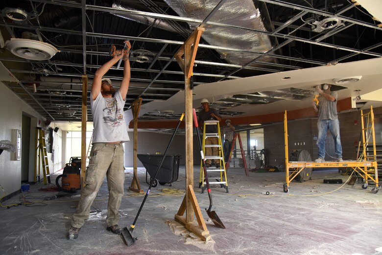 Construction workers remove the ceiling inside the R.P. Lee Youth Center at Peterson Air Force Base, Colo., Aug. 22, 2016. A concern with the ceiling on the second floor of the building arose after the replacement of the building’s new roof was completed. Construction is expected to take approximately 30 days. (U.S. Air Force photo by Airman 1st Class Dennis Hoffman)