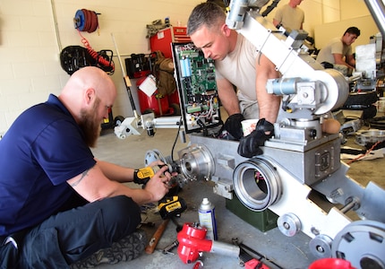 Technical Sgt. Dustin Frey, 140th Wing Civil Engineer Squadron explosive ordnance disposal technician, assists Jack Caylor, Northrop Grumman Remotec robotic instructor, remove a difficult component during a maintenance class at Peterson Air Force Base, Colo., Aug. 17, 2016. The 21st Civil Engineer Squadron EOD shop hosted the 140th Wing CES EOD out of Buckley Air Force Base, Colo., the 302nd Airlift Wing CES EOD at Peterson AFB, Colo., and the El Paso County bomb squad for an advanced maintenance course held here August 15-19. (U.S. Air Force photo by Staff Sgt. Amber Grimm) 