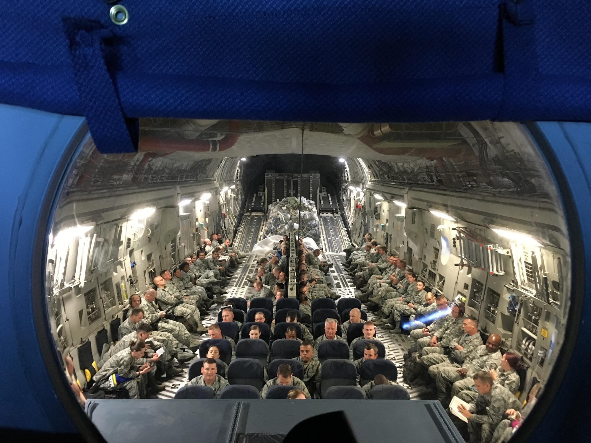 About a hundred 419th Fighter Wing reservists sit aboard a C-17 aircraft as it prepares to land at Joint Base Pearl Harbor-Hickam, Hawaii, where the Citizen Airmen completed two weeks of annual tour training.