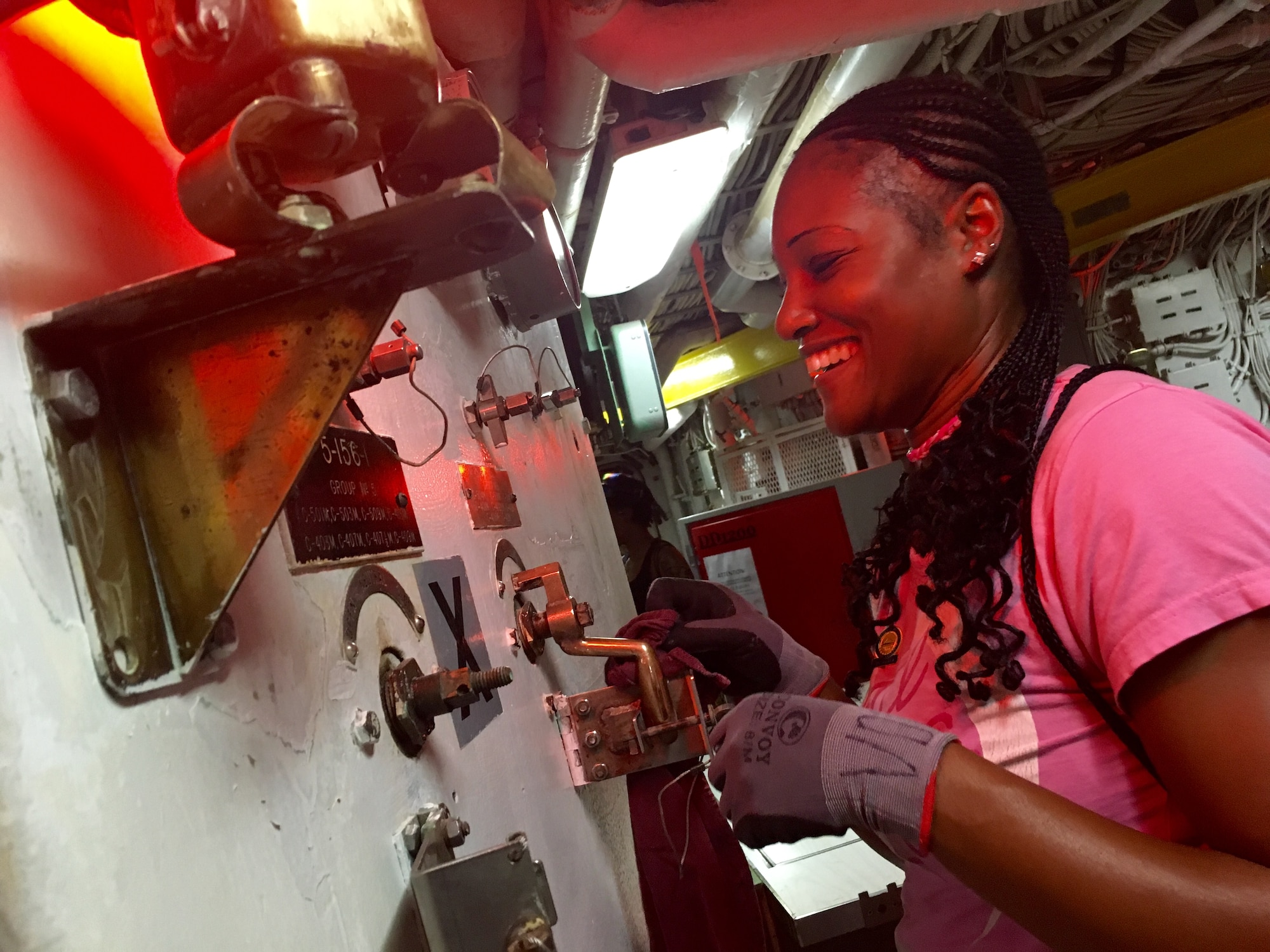 Capt. Anika Vines-Ogle, 419th Medical Squadron, polishes the brass aboard the USS Missouri in Honolulu, Hawaii. About 15 reservists from the 419th Fighter Wing took time on their day off to help clean the historic Navy ship during their two-week training on the island of Oahu. (U.S. Air Force photo/Bryan Magaña)