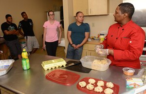 Sonnica Jones answers questions from students during a cooking class at the Community Commons at Langley Air Force Base, Va., Aug. 16, 2016. During the class, Jones provided information regarding recipes and cooking techniques to Airmen who live in the dorms as well as those who live in the local community. (U.S. Air Force photo by Staff Sgt. Teresa J. Cleveland)