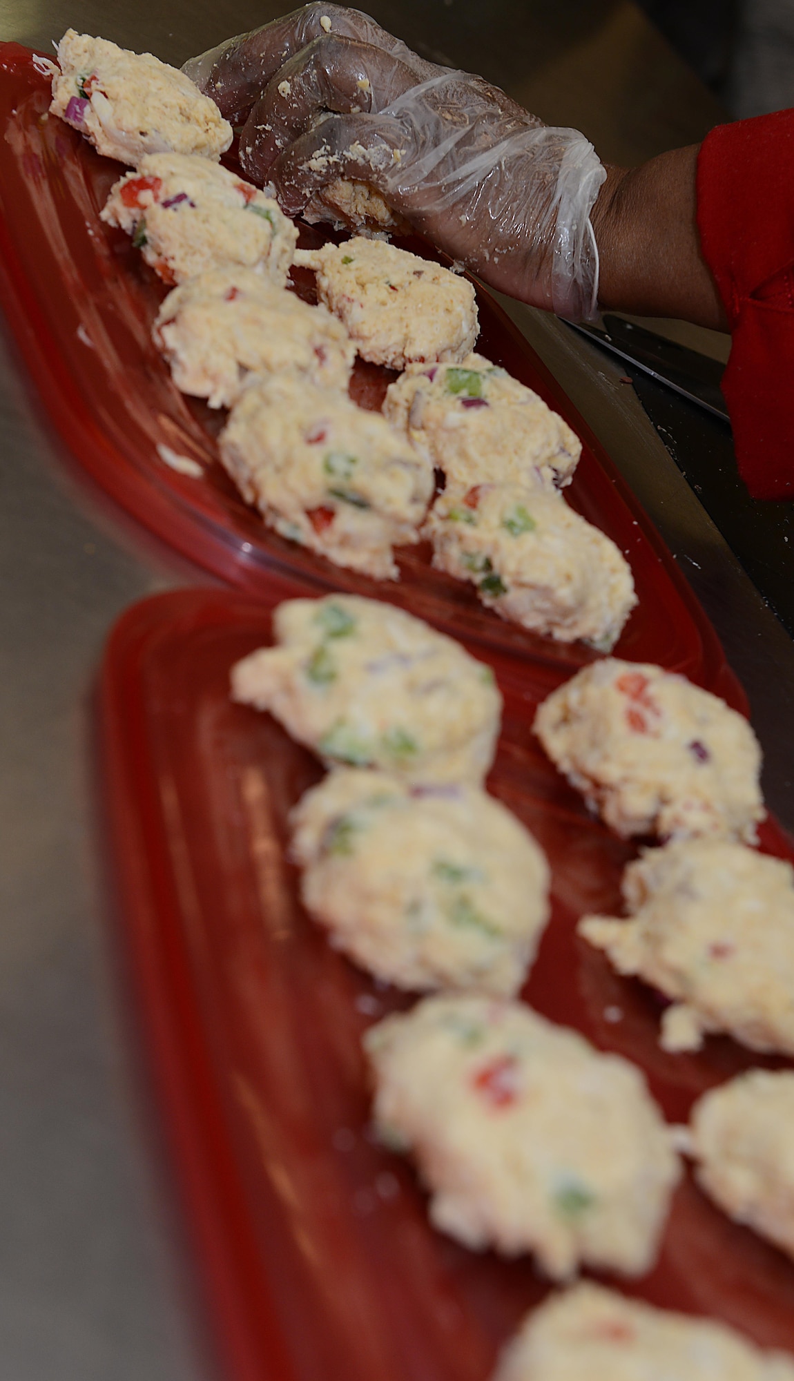 Sonnica Jones prepares a batch of crab cakes during a cooking class at the Community Commons at Langley Air Force Base, Va., Aug. 16, 2016. Class participants helped cook various menu items and then had the opportunity to taste them. (U.S. Air Force photo by Staff Sgt. Teresa J. Cleveland)