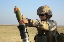 U.S. Marine Corps 1st Lt. Colleen McFadden, the deputy public affairs officer with the 11th Marine Expeditionary Unit (MEU), and native of Fort Washington, Md., loads an 81mm mortar system during exercise Red Reef 15 in the U.S. 5th Fleet area of responsibility, Dec 12, 2014. Red Reef is part of a routine theater security cooperation engagement plan between the U.S. Navy, U.S. Marine Corps and Royal Saudi Naval Forces that serves as an excellent opportunity to strengthen tactical proficiency in critical mission areas and support long-term regional security. (U.S. Marine Corps photo by Cpl. Jonathan R. Waldman/Released)