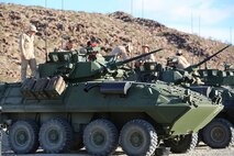 Marines with Light Armored Vehicle Platoon, Company B, Ground Combat Element Integrated Task Force, work atop their LAV-25s at Range 500, Marine Corps Air Ground Combat Center Twentynine Palms, California, Feb. 28, 2015. From October 2014 to July 2015, the GCEITF will conduct individual and collective level skills training in designated ground combat arms occupational specialties in order to facilitate the standards-based assessment of the physical performance of Marines in a simulated operating environment performing specific ground combat arms tasks. (U.S. Marine Corps photo by Cpl. Paul S. Martinez/Released)