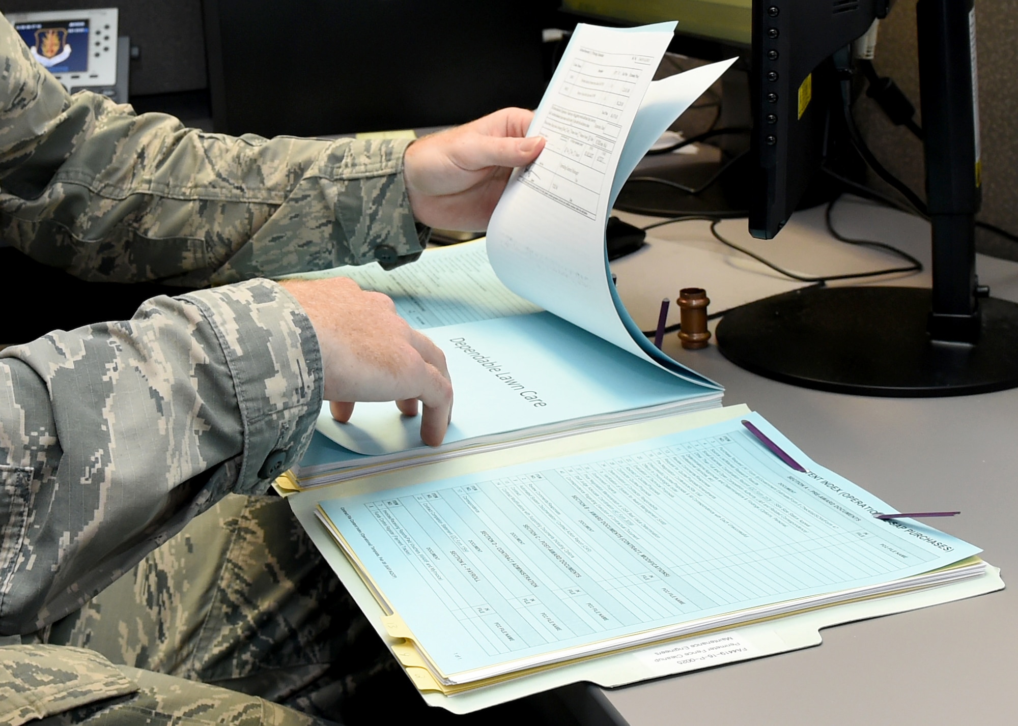 U.S. Air Force Airman 1st Class Jason Easley, 97th Contracting Flight contracting specialist, reads through a contract file, August 17, 2016 at Altus Air Force Base, Okla. The 97th Contracting Flight is responsible for making large military purchases such as equipment and hiring contractors to support Altus’ mission of forging combat mobility forces and deploying Airman warriors. (U.S. Air Force photo by Airman 1st Class Kirby Turbak/Released)