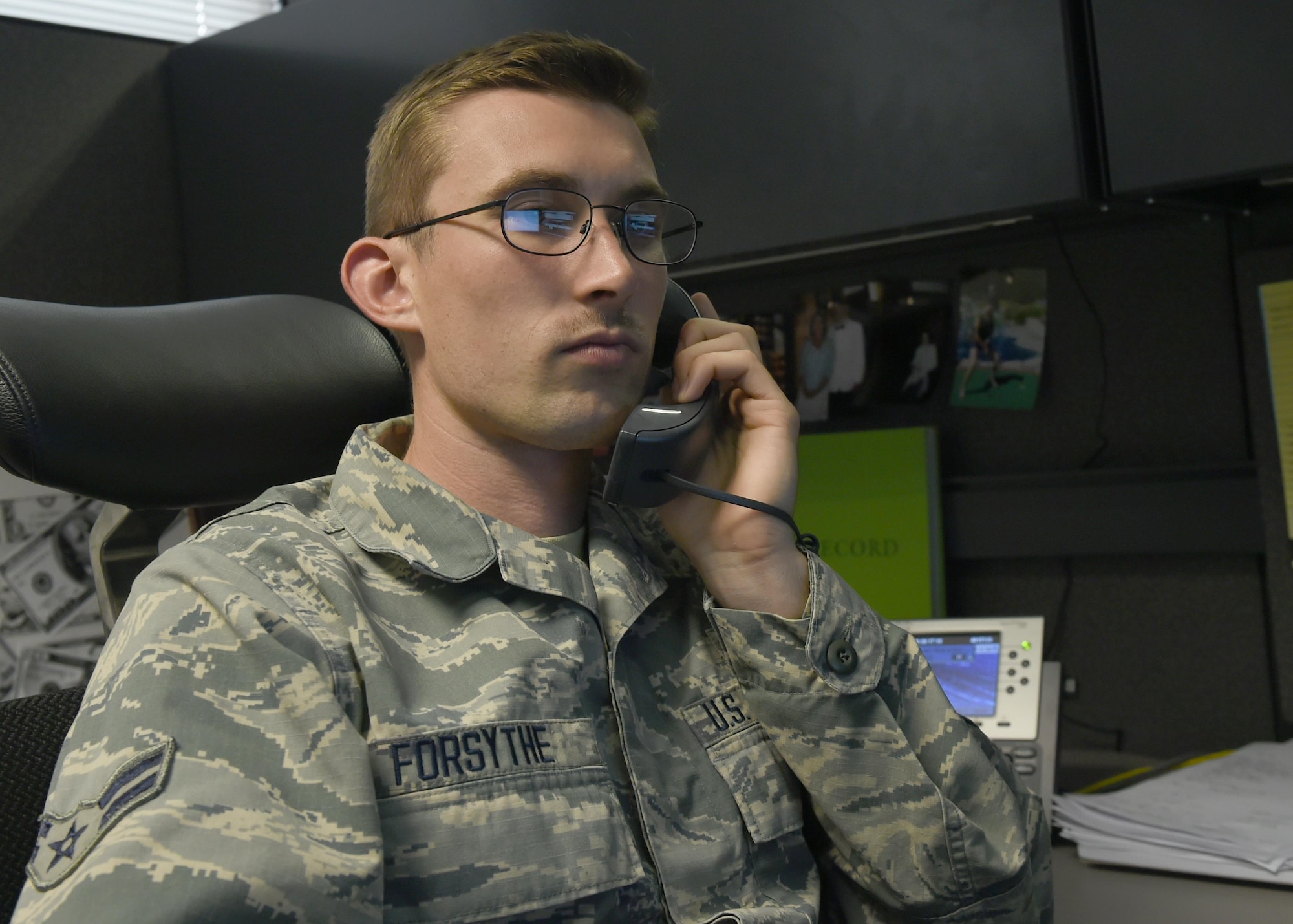 U.S. Air Force Airman 1st Class Trevor Forsythe, 97th Contracting Flight contracting specialist, speaks with a client, August 17, 2016, at Altus Air Force Base Okla. The 97th Contracting Flight is responsible for making large military purchases such as equipment and hiring contractor to support Altus’ mission of forging combat mobility forces and deploying Airman warriors. (U.S. Air Force photo by Airman 1st Class Kirby Turbak/Released) 