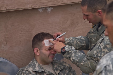 Spc. Carlo Deldonno, U.S. Army Reserve Best Warrior Competition runner-up in the Soldier category, provides casualty care and writes the time a tourniquet was applied on a wounded Soldier during  training at Fort Harrison, Mont., August 5, 2016. The USAR BWC winners from the NCO and Soldier category are going through rigorous training, leading up to their appearance at Fort A.P. Hill later this year for the Department of Army BWC. (U.S. Army Reserve photo by  Brian Godette, USARC Public Affairs)(U.S. Army Reserve photo by  Brian Godette, USARC Public Affairs)