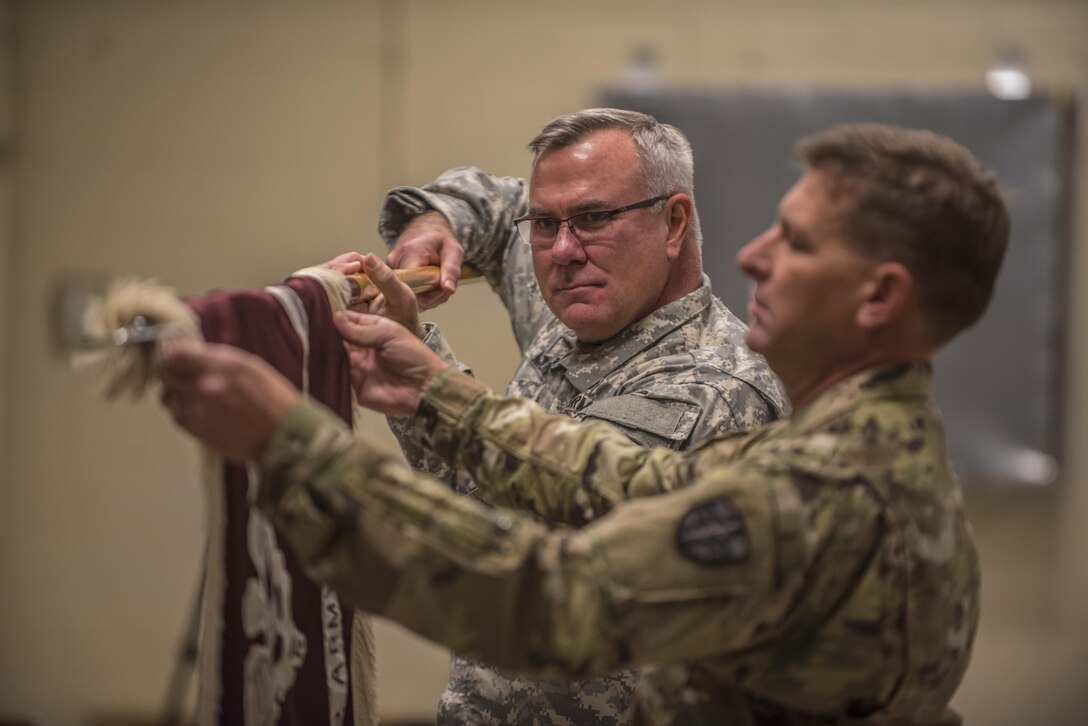 Col. James H. Murphy, 3297th United States Army Hospital Battalion commander, prepares to case the Battalion Colors during a Color Casing ceremony held in Charlotte, N.C., Aug. 20. (U.S. Army Reserve photo by Sgt. 1st Class Brian Hamilton/ released)