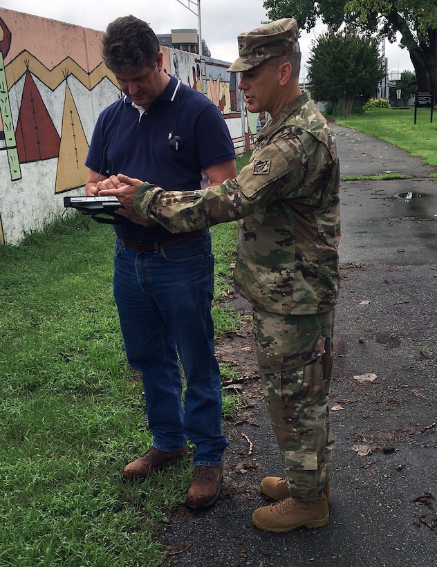 Mark Fredricks a civil engineer in the Little Rock District's Engineering and Construction Division, explains the Levee Inspection Tool to Col. Robert G. Dixon the Little Rock District commander.