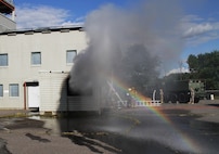 FORT MCCOY, Wis. – Water, smoke and soot spew from a window after U.S. Army Reserve firefighters from the 237th Firefighter Detachment, Sturtevant, Wis., vent the room in the burn house following suppressing a fire during an exercise at Fort McCoy, Aug. 21, 2016. The training helped firefighters find weaknesses in their techniques, while learning new ones. (U.S. Army Reserve Photo by Sgt. Quentin Johnson, 211th Mobile Public Affairs Detachment/Released)