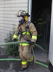 FORT MCCOY, Wis. – U.S. Army Reserve firefighters, from the 237th Firefighter Detachment, Sturtevant, Wis., exit the burn house after putting out a fire during an exercise at Fort McCoy, Aug. 21, 2016. Firefighter teams took turns entering the house and extinguishing fires to learn ever changing firefighting techniques. Firefighters can put out a 300-square foot fire in under a minute using either a water or foam-based method. (U.S. Army Reserve Photo by Sgt. Quentin Johnson, 211th Mobile Public Affairs Detachment/Released)