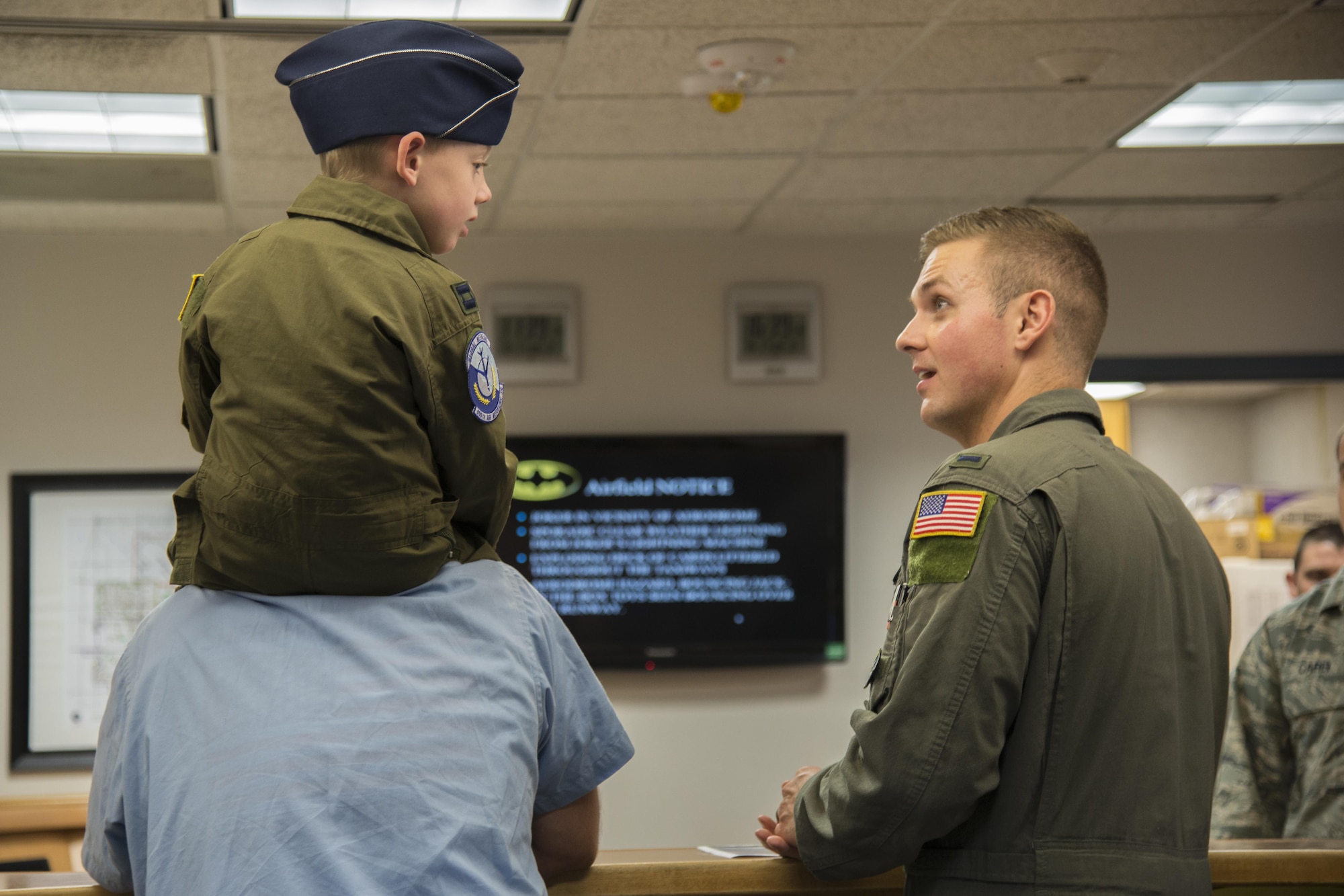 First Lt. Robert Frisch, 458th Airlift Squadron, meets with Hayden Brown for an ops brief before he boards a C-21, Aug. 17, 2016, Scott Air Force Base, Ill. Scott AFB teamed up with Alton VFW 1308 and hosted Hayden as an honorary pilot for the day. Hayden Brown has a rare degenerative disease called Metachromatic Leukodystrophy, commonly referred to as MLD, and throughout this illness, he has shown tremendous courage and determination. (U.S. Air Force Airman 1st Class Melissa Estevez)
