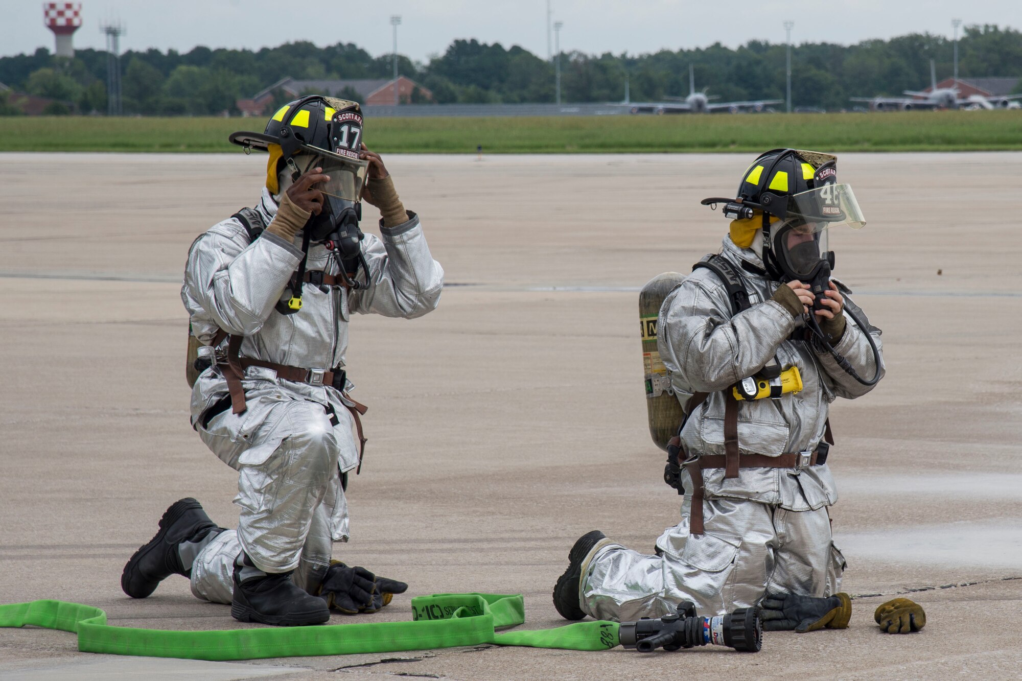 Firefighters from Fire Station 1 prepare to rescue Hayden Brown from a C-21 during his mission to help Batman find the Joker, Aug. 17, 2016, Scott Air Force Base, Ill. Scott AFB teamed up with Alton VFW 1308 and hosted Hayden as an honorary pilot for the day. Hayden Brown has a rare degenerative disease called Metachromatic Leukodystrophy, commonly referred to as MLD, and throughout this illness, he has shown tremendous courage and determination. (U.S. Air Force Airman 1st Class Melissa Estevez)