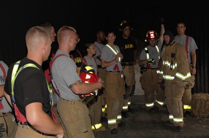 FORT MCCOY, Wis. – U.S. Army Reserve firefighters discuss fire scenarios in the burn tower on Fort McCoy, Wis., Aug. 21, 2016. A total of five units from Wisconsin, Illinois and South Dakota participated in the training. The units trained to put out a fire and also search and rescue.  (U.S. Army Reserve Photo by Sgt. Quentin Johnson, 211th Mobile Public Affairs Detachment/Released)