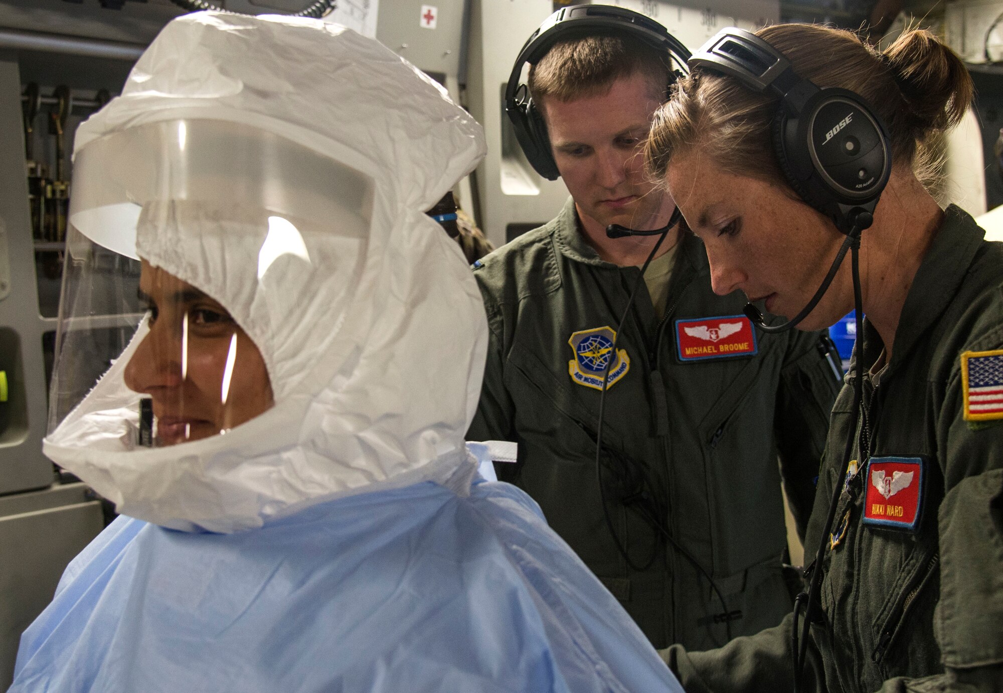 Captains Micheal Broome and Nicole Ward, 375th Aeromedical Evacuation Squadron flight nurses, prepare Capt. Andrea De Oliveira, 375th AES flight nurse to enter a Transportation Isolation System for training, Aug. 18, 2016. The TIS is used to transport sick and contagious patients to more definitive care without compromising the safety of the crew. (U.S. Air Force Photo by Airman Daniel Garcia)