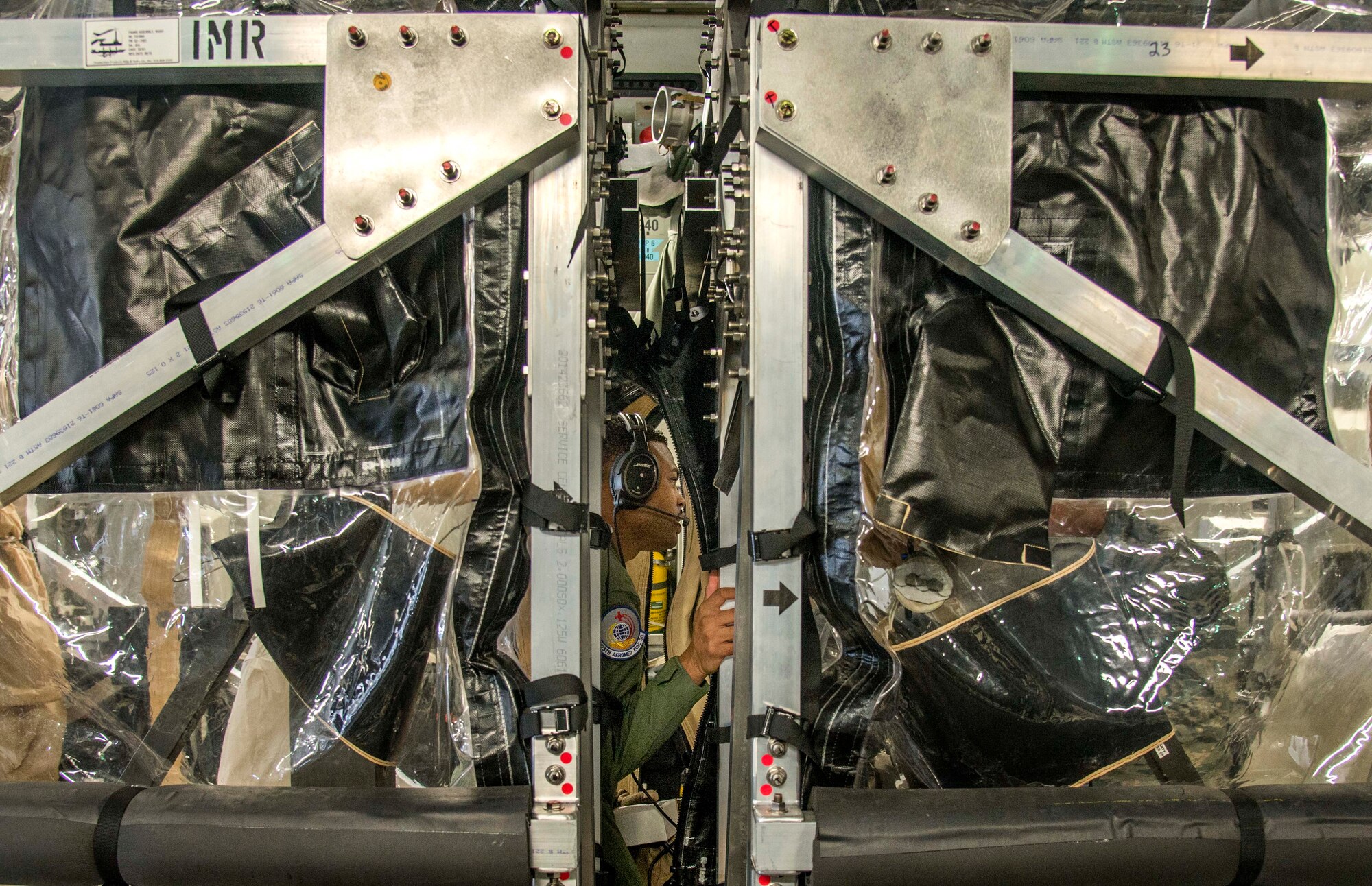 Staff Sgt. Sean McCurbin, 375th Aeromedical Evacuation Squadron aeromedical evacuation technician, explores a Transportation Isolation System used for training, Aug. 18, 2016. The TIS is used to transport sick and contagious patients to more definitive care without compromising the safety of the crew. (U.S. Air Force Photo by Airman Daniel Garcia)