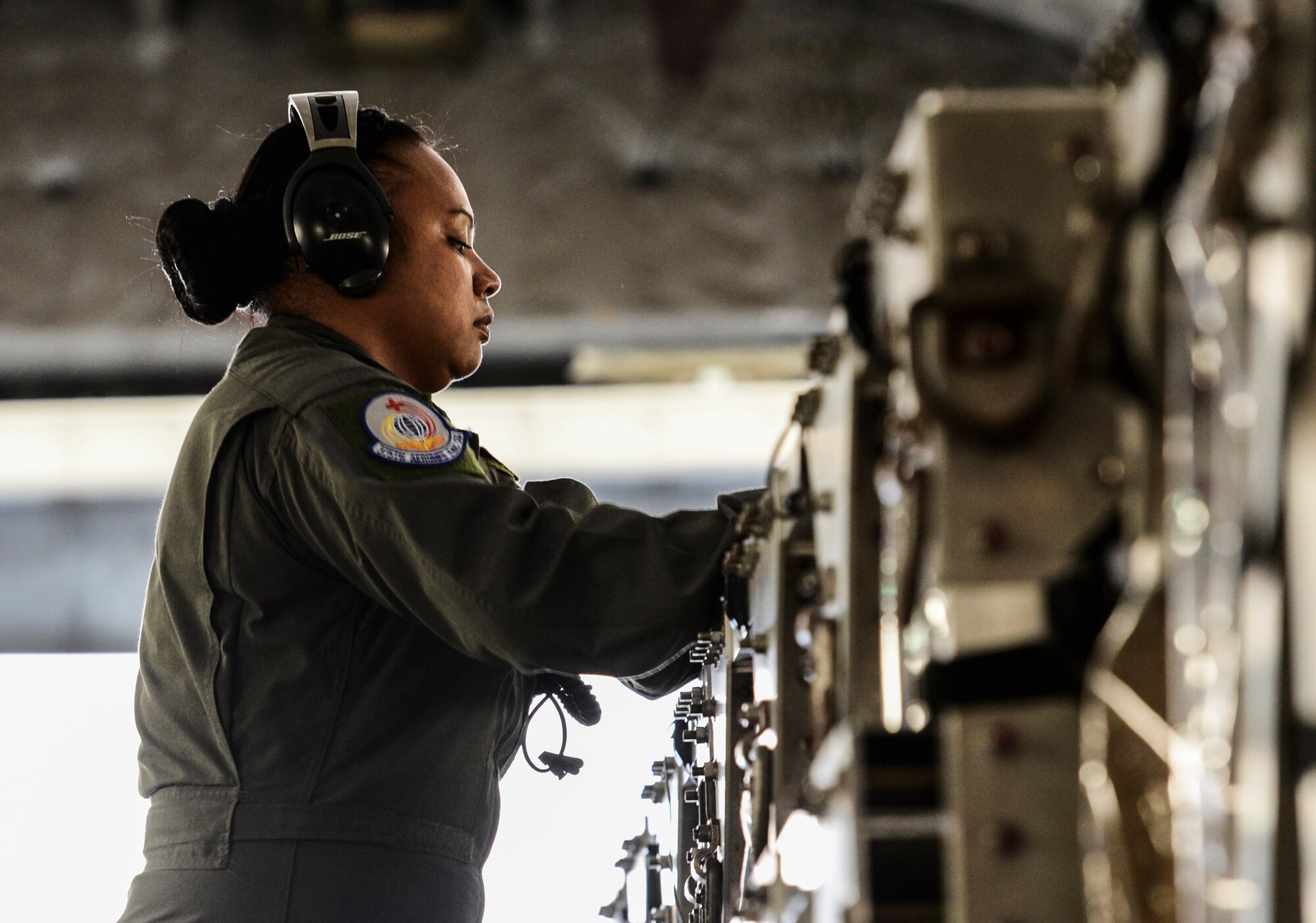 Tech. Sgt. Renee San Nicolas, 375th Aeromedical Evacuation Squadron  aeromedical evacuation technician, connects air ducts to the Transporation Isolation System to provide air in and out of the TIS. The TIS is used to transport sick and contagious patients to more definitive care without compromising the safety of the crew. (U.S. Air Force Photo by Airman Daniel Garcia)