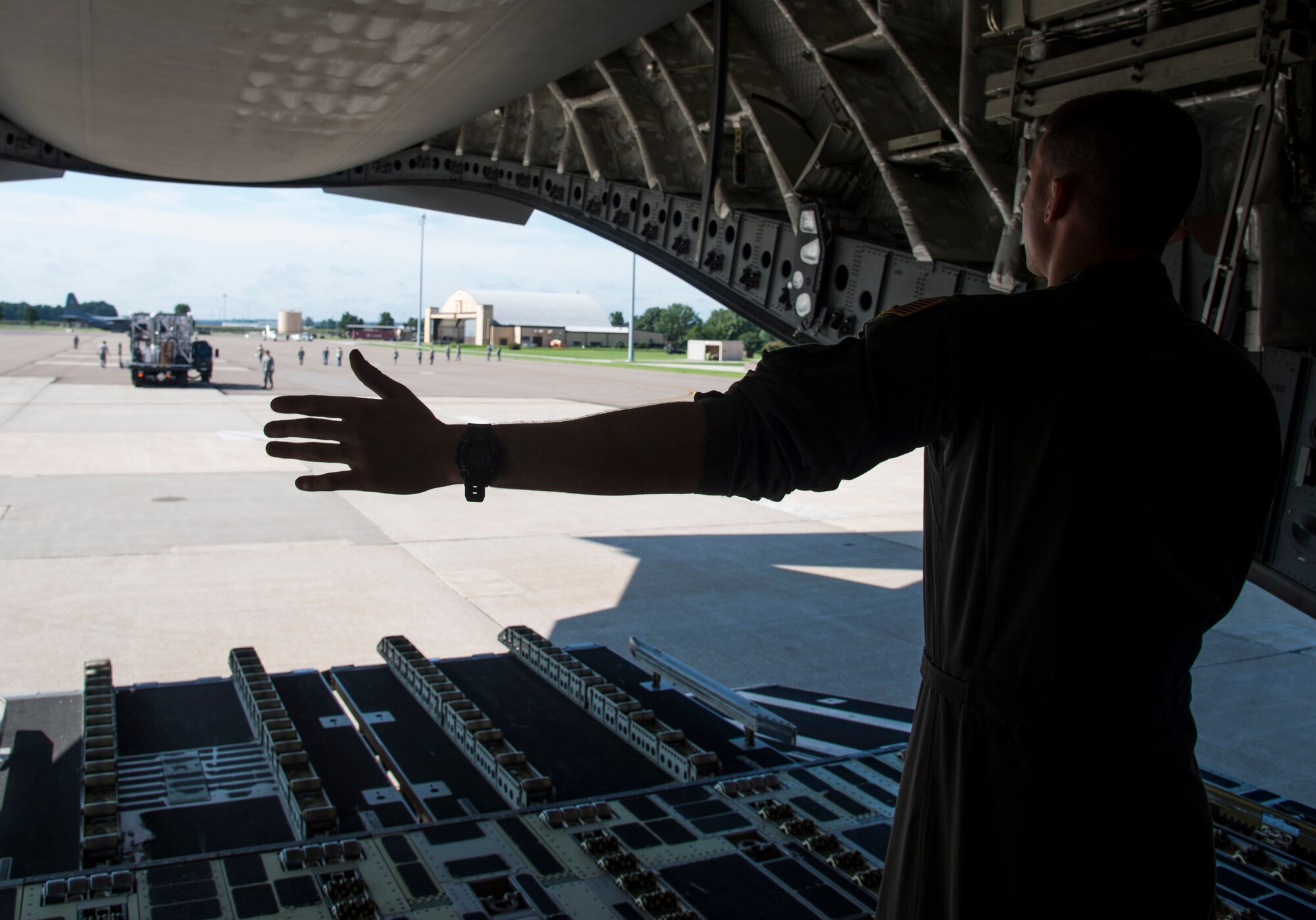 Airman Jeff Mcgee, 3rd Airlift Squadron loadmaster, ushers in a Transportation Isolation System onto a C-17 Globemaster from Dover Air Force Base at Scott Air Force Base on Aug. 18, 2016. The 375th Aeromedical Evacuation Squadron used the TIS during training as a containment tool to transport sick and contagious patients to more definitive treament without compromising the safety of the crew. (U.S.Air Force Photo by Airman Daniel Garcia)