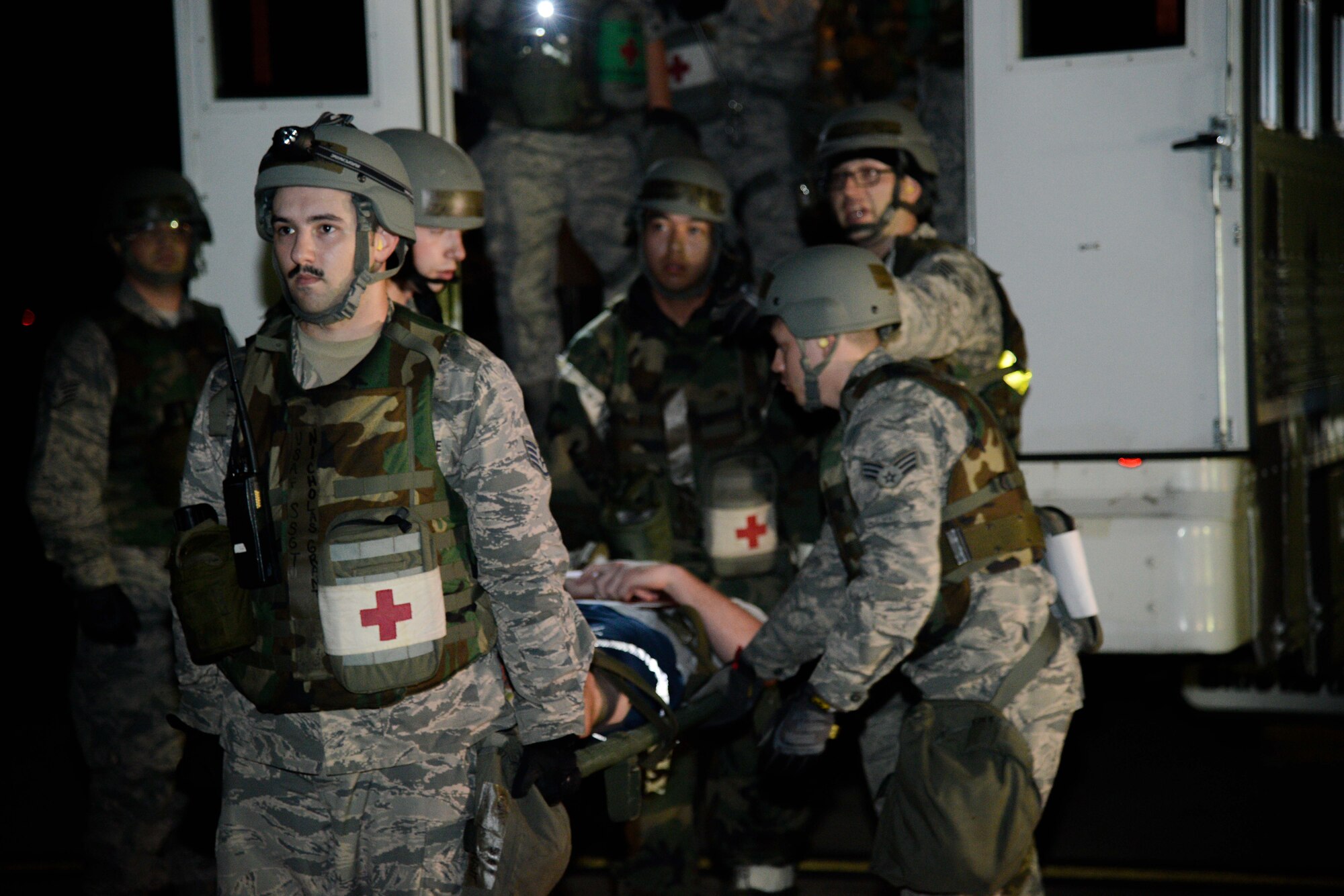 U.S. Air Force Staff Sgt. Nicholas Grant, 51st Aerospace Medicine Squadron medical technician, and Airmen from the 51st AMDS transport a simulated injured service member to a C-130 Hercules during a medical evacuation scenario for Exercise Beverly Herd 16-2 at Osan Air Base, Republic of Korea, Aug. 25, 2016. In the event of a mass casualty incident, the 51st AMDS plays a critical role in the survivability of the patients, and its personnel train to ensure this need is met.  (U.S. Air Force photo by Senior Airman Dillian Bamman)