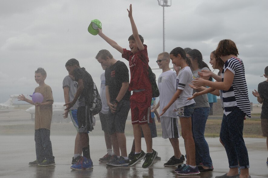 Laughlin’s junior firedogs get sprayed by a P-19 Airfield Rescue Firefighting Vehicle during a week-long youth firefighting camp, on Laughlin Air Force Base, Texas, Aug. 16, 2016. The vehicle is capable of pumping up to 500 gallons of water per minute through its hose. (U.S. Air Force photo/Airman 1st Class Benjamin N. Valmoja)