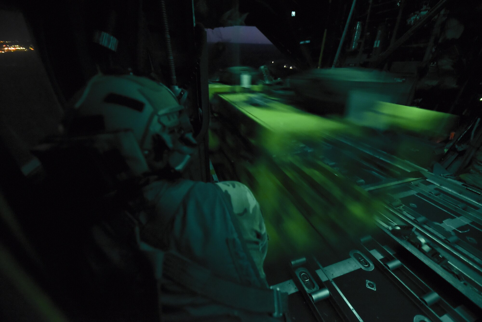 Tech. Sgt. Vince Telmanik, a loadmaster with the 15th Special Operations Squadron, watches as cargo flows out the back of a MC-130H Combat Talon II aircraft during a mass container deployment systems exercise, part of Task Force Exercise Olympus Archer, Aug. 21, 2016.  Olympus Archers' focus is to maximize training opportunities for more than 230 Air Commandos with the 1st Special Operations Wing with an emphasis on medical operations in conjunction with flying operations. (U.S. Air Force photo by Staff Sgt. Christopher Callaway)