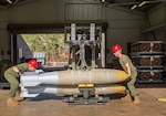 Sgt. Joel Farmer, left, aviation ordnance technician and quality assurance officer, and Cpl. Michael Konicki, right, aviation ordnance technician team member, assigned to Marine Aviation Logistics Squadron 12, load bombs onto a bomb skid during Southern Frontier at Royal Australian Air Force Base Tindal, Australia, Aug. 22, 2016. The bomb skid will then be transported to the line, where the munitions are loaded on to aircraft. Southern Frontier afforded Iwakuni Marines the opportunity to train with high explosive weapon body groups typically not used in Japan, while expanding technical and tactical proficiency in their craft. Munitions built during this training are in support of Marine Fighter Attack Squadron (VMFA) 122, who also gain experience and qualifications in low altitude, air-ground, high explosive ordnance delivery at the unit level.
